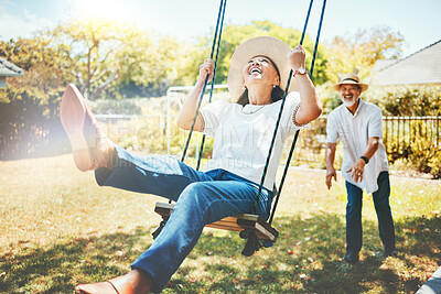 Buy stock photo Woman, happy and fun on swing in retirement, playful and joy in summer vacation for quality time. Elderly people, support and love in relationship, funny and laugh for silly, goofy and holiday