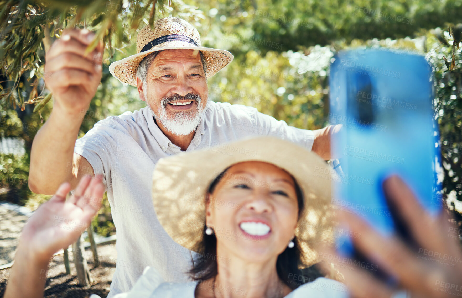 Buy stock photo Senior couple, video call and outdoor in garden, wave hello and smile in sunshine, trees and talking on web. Mature woman, elderly man and contact with webinar, live streaming or vlogging in backyard