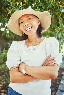 Buy stock photo Mature woman, portrait and arms crossed in garden with sun hat for summer, vacation and outdoor with smile, Japanese person, happy and spring in backyard, park and nature for walk on path in Tokyo