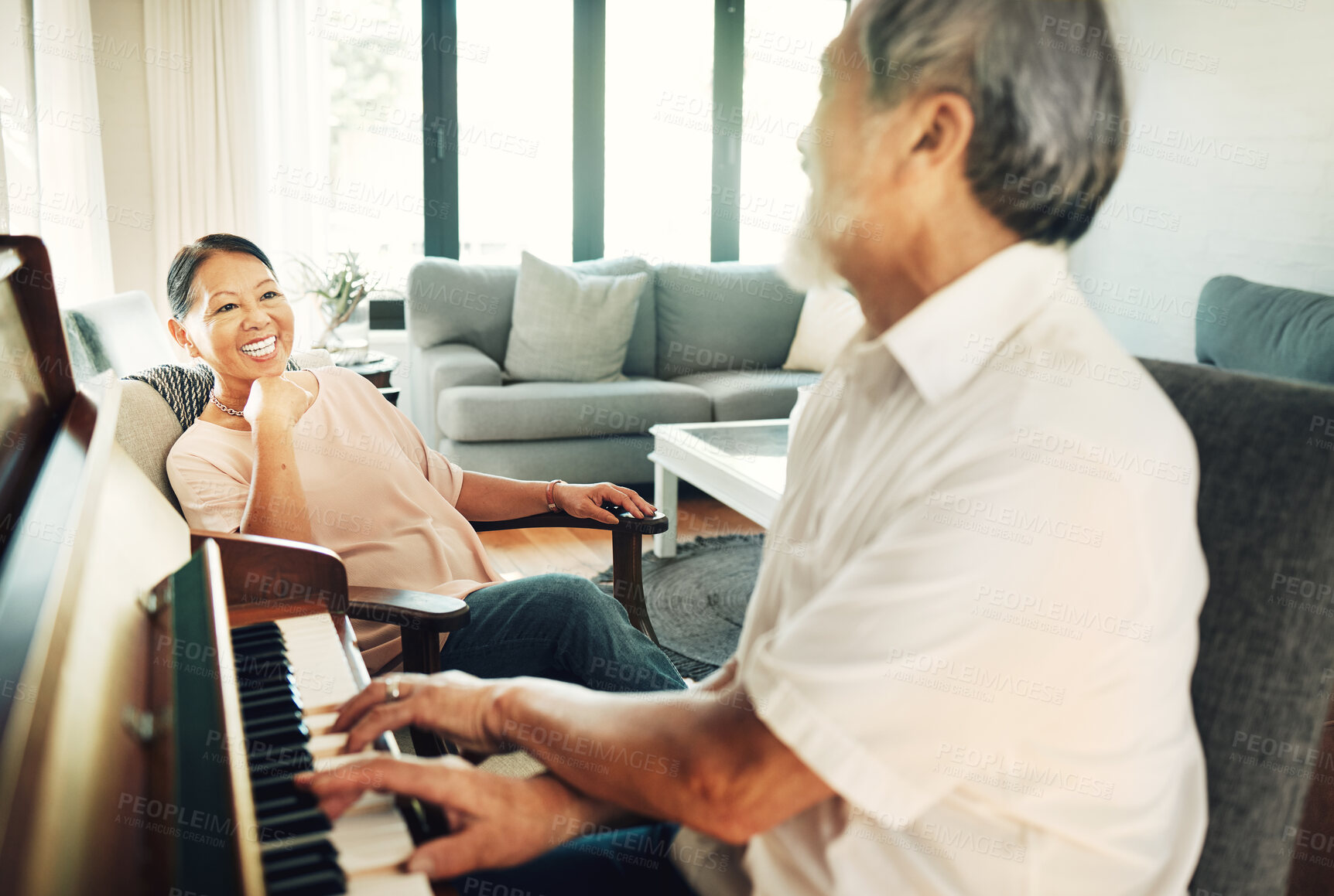 Buy stock photo Happy, piano and senior man playing for music in living room with wife for bonding, entertainment or having fun. Instrument, smile and elderly Asian couple in retirement enjoy keyboard at modern home