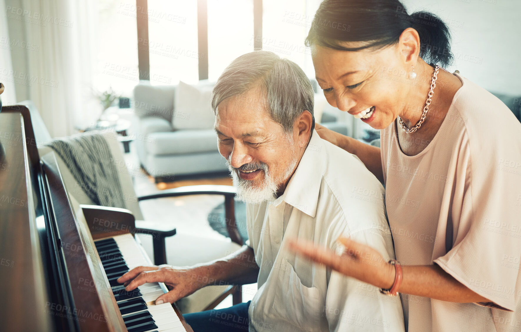 Buy stock photo Senior couple playing piano for music in living room for bonding, entertainment or having fun. Happy, smile and elderly Asian man and woman in retirement enjoying keyboard instrument at modern home.