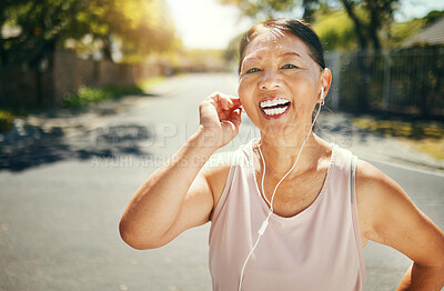 Fitness, music earphones and portrait of Asian woman outdoor for sports training, exercise and healthy body. Happy face, mature athlete listening to radio in street and excited for streaming podcast