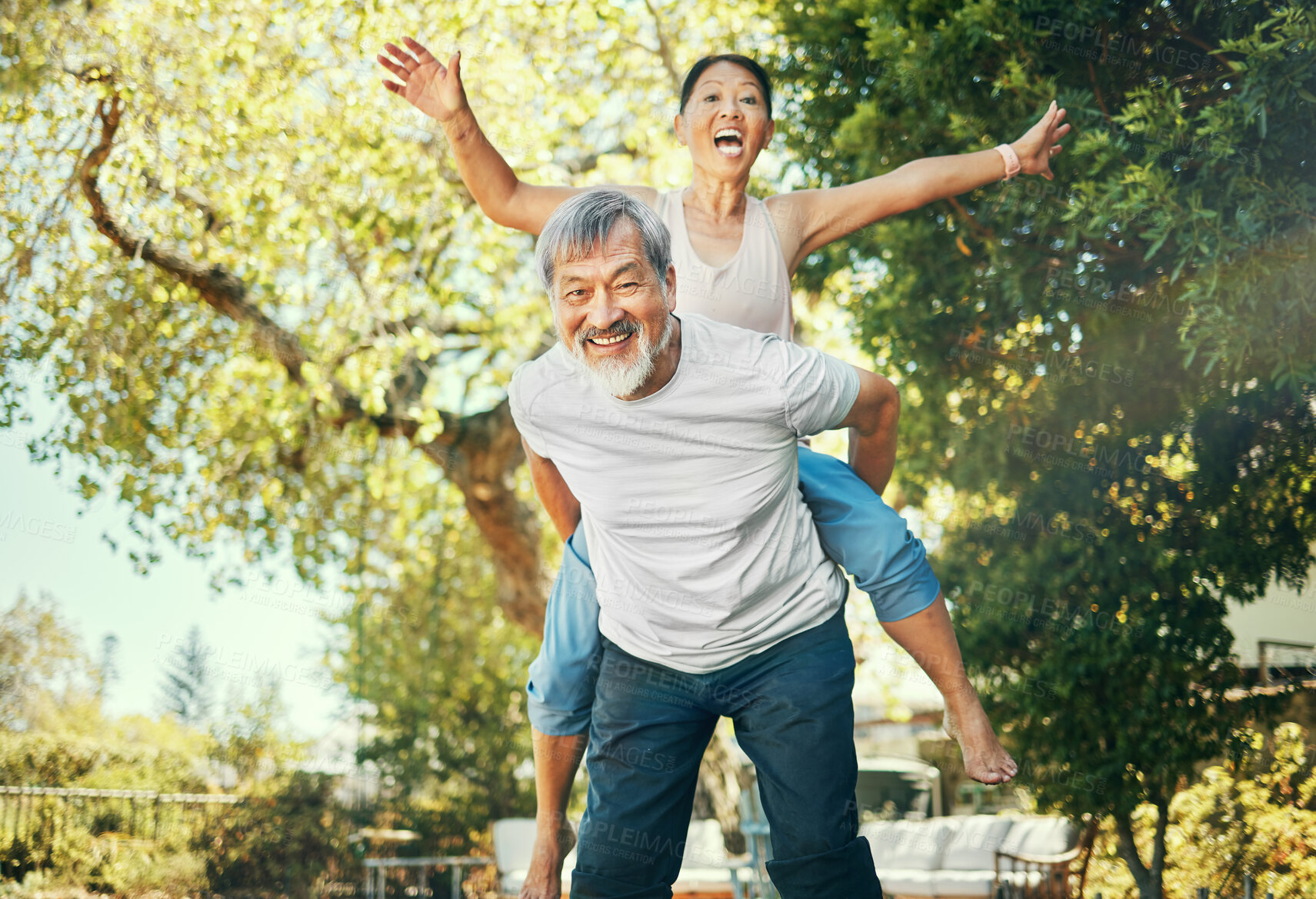 Buy stock photo Couple, piggyback and nature to smile in portrait, excited and playful in freedom, energy and joy. Happy elderly asian people, face and date in summer, laughing and support for crazy in retirement