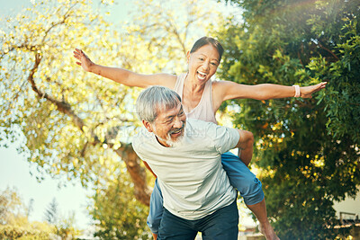 Buy stock photo Couple, smile and piggyback in nature for fun, excited and playful in freedom, energy and joy. Happy elderly asian people, airplane and flying in summer, laugh and support for crazy in retirement