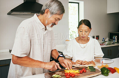 Buy stock photo Couple, cooking and cutting vegetables in kitchen, diet and nutrition, hobby and bonding in retirement. Happy senior people, healthy food and produce for lunch, culinary skills and prepare meal