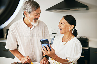 Buy stock photo Home, influencer and senior couple with a smartphone, social media and connection with conversation. Kitchen, elderly man or old woman with a cellphone, content creation and digital app with internet