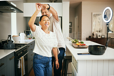 Buy stock photo Happy couple, together and dancing while cooking in kitchen for fun, energy or bond in romance. Asian people, married and smile for love, excited or laugh with spin with preparation of dinner in home