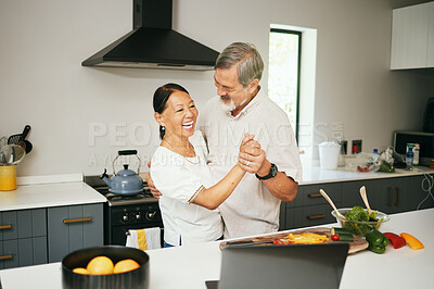 Buy stock photo Senior couple, dancing and kitchen while cooking, happiness and love at home, fun and romantic. Retirement, bonding together and smile for food, elderly and quality time with joke, retired or elderly