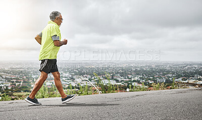 Buy stock photo Senior man, running and fitness on mountain for outdoor exercise, training or workout on mockup. Mature male person, athlete or runner in sports, health and wellness on road for hiking or trekking