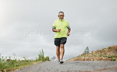 Buy stock photo Senior man, running and road in nature, countryside or forest with exercise for marathon, cardio and health mockup. Fitness, training and person walking on path in workout, sport or run in retirement