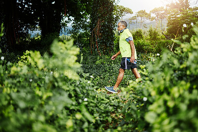 Buy stock photo Senior man, fitness walk and forest in profile, green and outdoor for wellness in retirement. Mature person, exercise and workout for health, hiking and freedom in woods, countryside or nature park