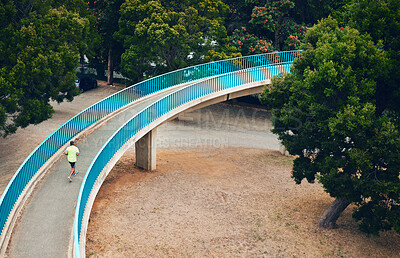 Buy stock photo Above, man and running on bridge in nature, countryside or outdoor in environment with path in woods. Athlete, run or walking on road for cardio, fitness or exercise in forest with eco infrastructure