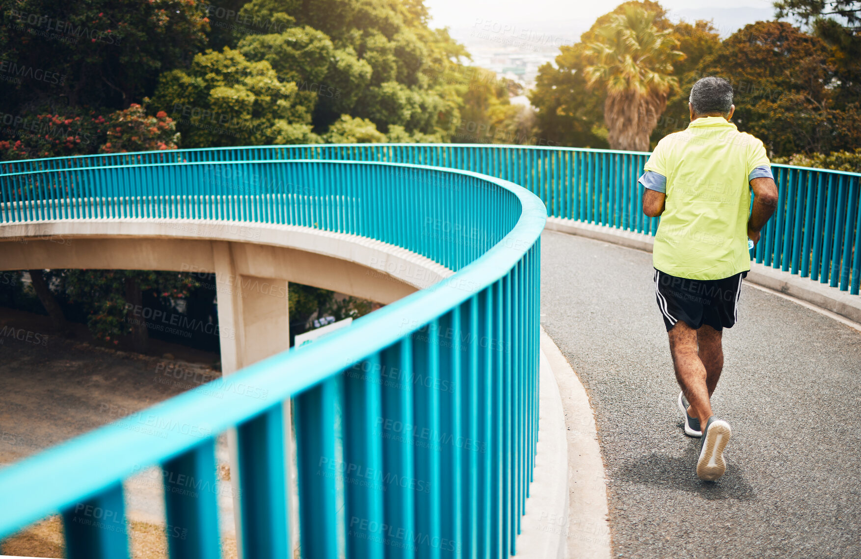 Buy stock photo Old man on bridge, running for fitness and cardio, back view with speed and training for marathon, wellness and vitality. Runner in street, performance and challenge with exercise, health and workout