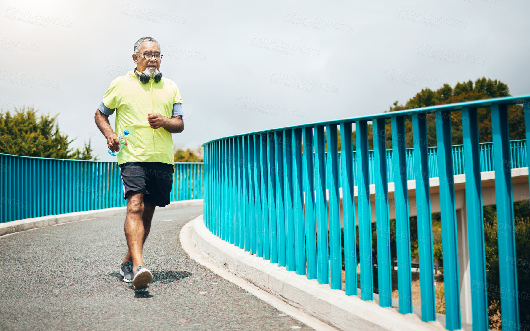 Buy stock photo Senior man on bridge, speed walk for fitness and cardio,  training or running with wellness and vitality. Runner in street, performance and challenge with exercise, health and workout in retirement