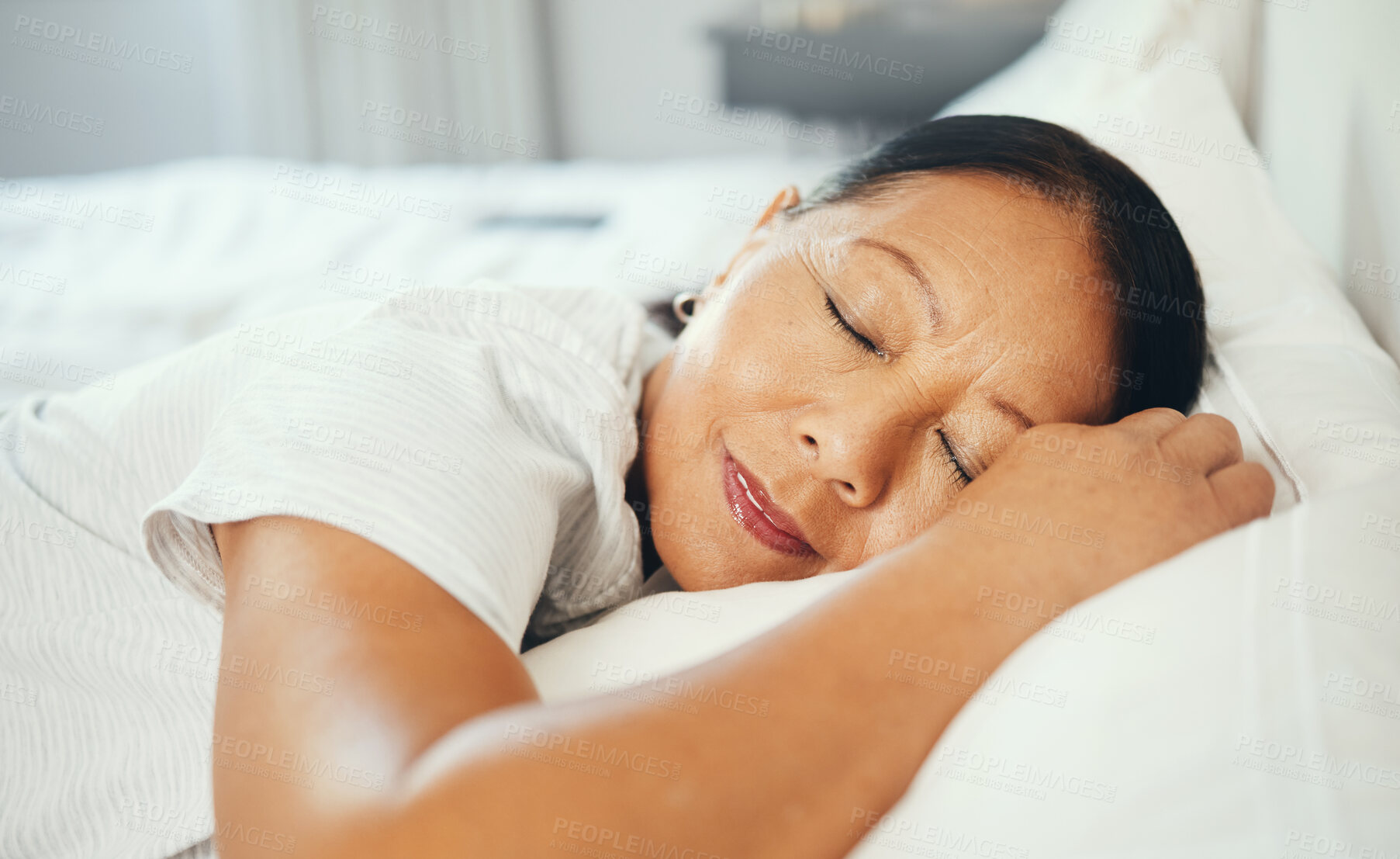 Buy stock photo Mature, woman and calm while sleeping in bed with good dream, head on pillow and peace. Asian, elderly person and face in bedroom, alone and smile with happiness while rest with retirement in home