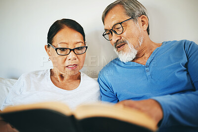 Buy stock photo Bible, home or senior couple reading book for prayer, support or hope in bed to worship together. Education, Asian man or mature woman learning or studying God for grace in religion with love or care