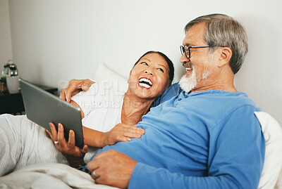 Buy stock photo Tablet, mature or happy couple in bed for movie watching on website subscription via internet connection. Meme, home or mature woman laughing at comedy with an Asian man streaming film on tech online