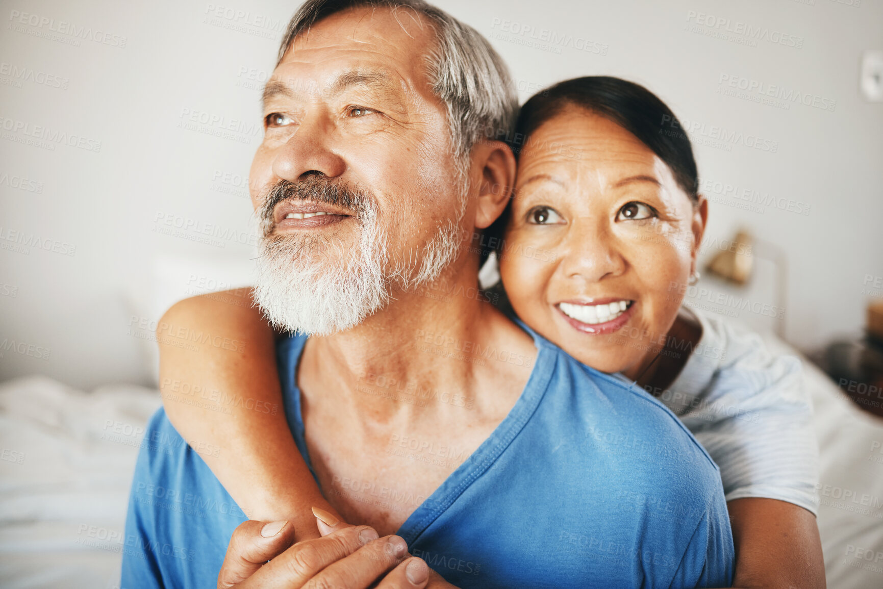 Buy stock photo Love, smile and senior couple hugging in the bedroom for bonding, thinking and relaxing together. Happy, care and elderly Asian man and woman in retirement embracing for connection by modern home.