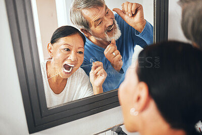 Buy stock photo Old couple, flossing in mirror and dental in bathroom, hygiene and teeth whitening during morning routine at home. Fresh breath, orthodontics and reflection with thread, health and oral care  