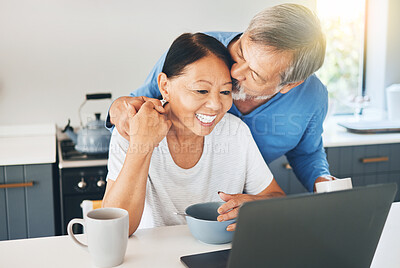 Buy stock photo Couple, love and laptop in kitchen for morning news, happy planning and watch video, streaming service or work from home. Mature woman and man with breakfast, kiss and computer, internet or website