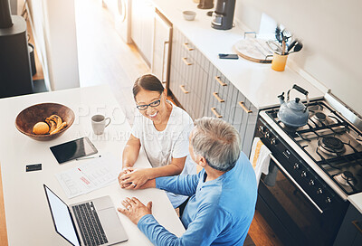 Buy stock photo Couple, laptop and home documents for finance, loan payment and mortgage planning, support and love in kitchen. Mature woman and man holding hands for banking and paperwork solution on computer above