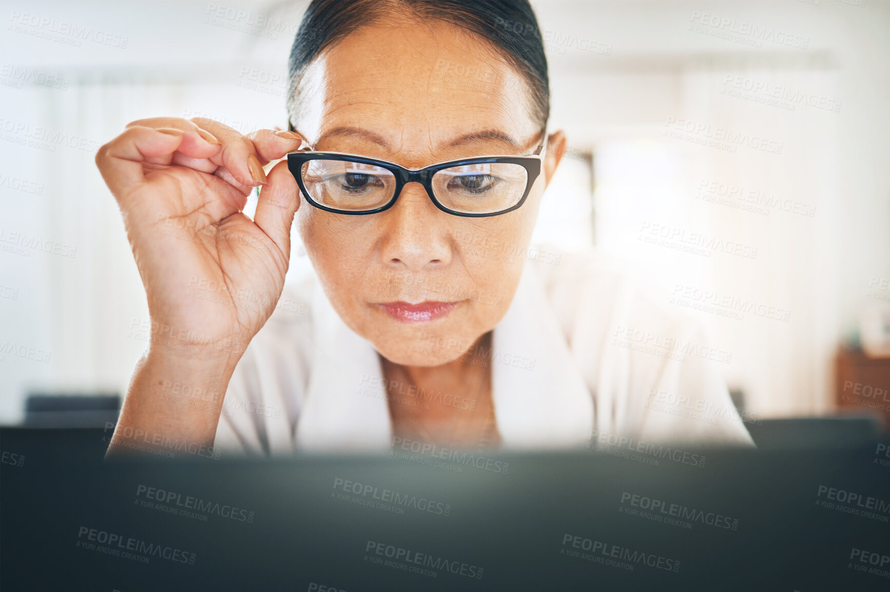 Buy stock photo Mature woman, glasses and reading on computer for home blog or article on eye care, health and lens sale or discount. Business person with vision and laptop in work from home job or optometry website