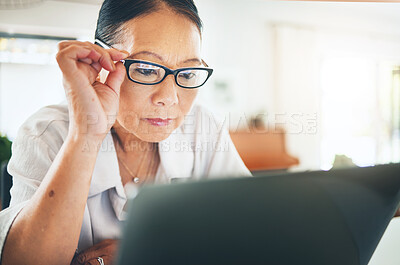 Buy stock photo Mature woman, glasses and reading on laptop for blog or article on eye care, health and lens sale or discount. Business person with vision and computer in work from home job or optometry website