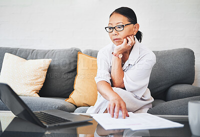 Buy stock photo Woman thinking, laptop and documents with home budget, life insurance research or financial paperwork on sofa. Mature person on computer, reading information and registration for loan, bank or policy