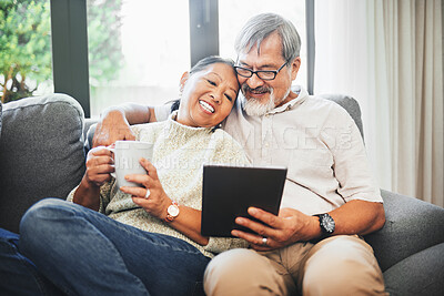 Buy stock photo Tablet, coffee and senior couple on sofa bonding, relaxing and networking on social media together. Happy, digital technology and elderly man and woman in retirement scroll on mobile app or internet.