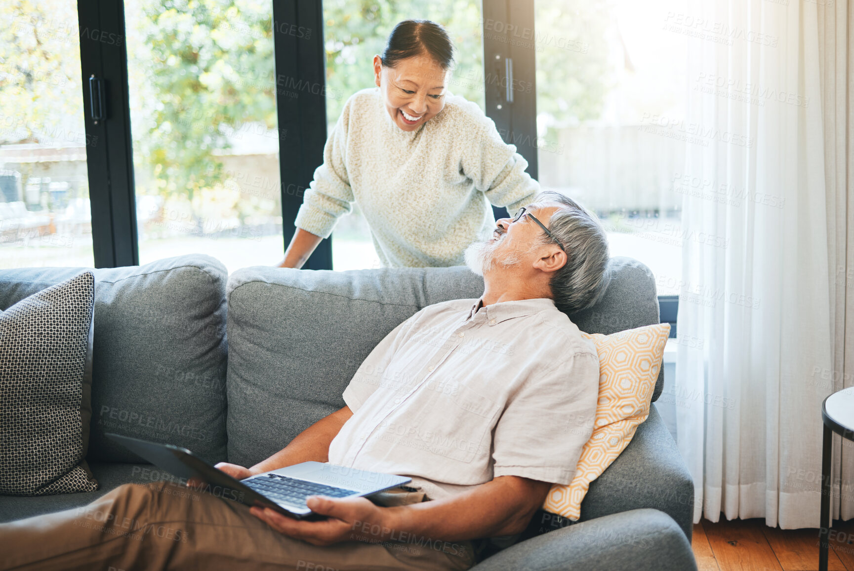 Buy stock photo Laptop, smile and mature couple on sofa in home, love or bonding together. Computer, happy man and Asian woman in living room on website, online social media or communication for healthy relationship