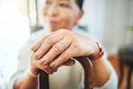 Hands, walking stick and woman in home for support, healthcare and help in retirement. Closeup, lonely widow and senior with disability with cane for parkinson, arthritis and rehabilitation of stroke