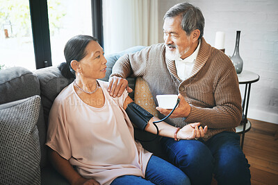 Buy stock photo Hypertension, healthcare and senior couple in living room with equipment for blood pressure. Sick, love and elderly man with medical tool for woman in retirement in the lounge of modern home together