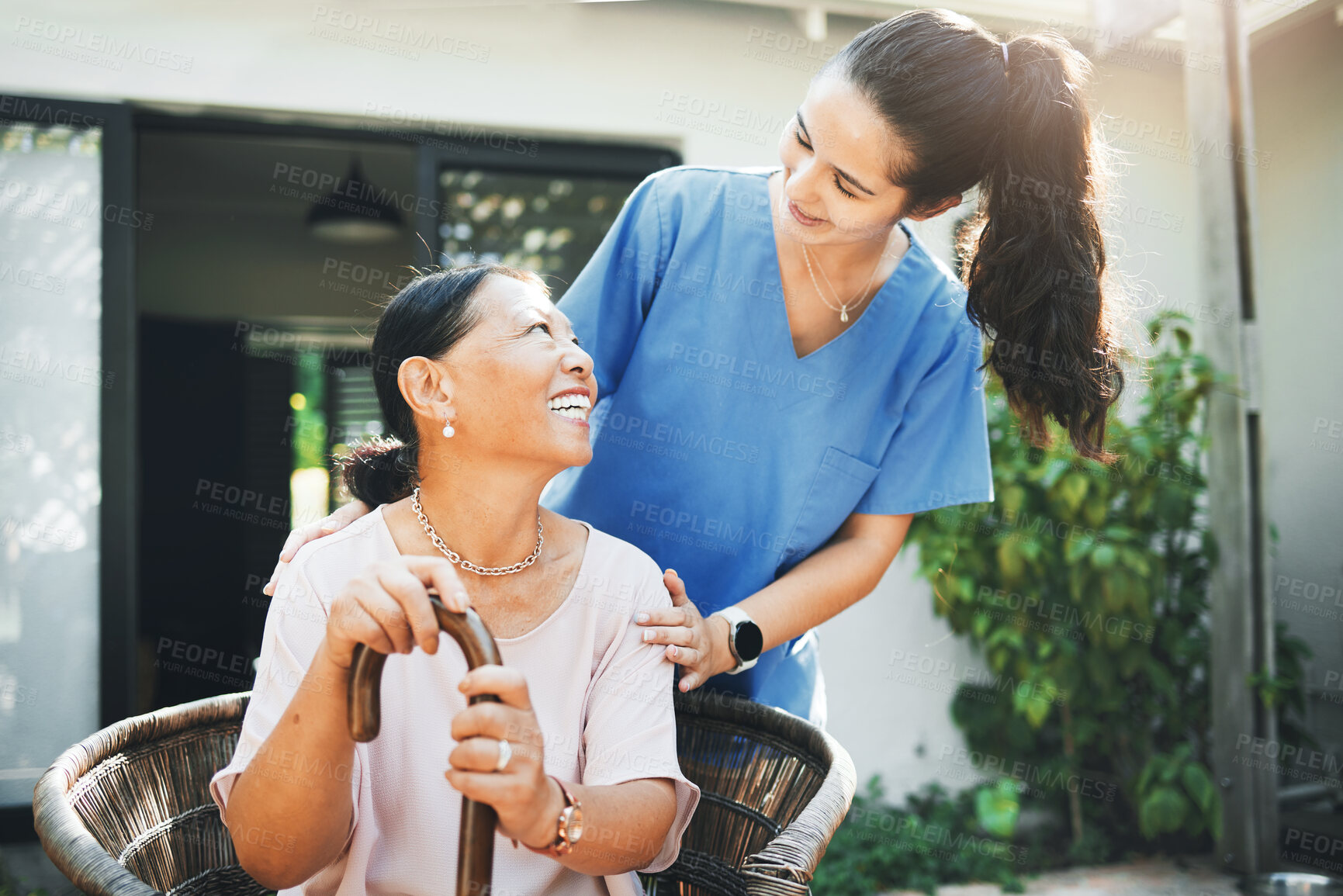 Buy stock photo Senior woman, happy nurse and garden for health support, 
conversation and wellness in retirement or nursing home. Medical doctor talking to elderly patient with disability and walking stick outdoor