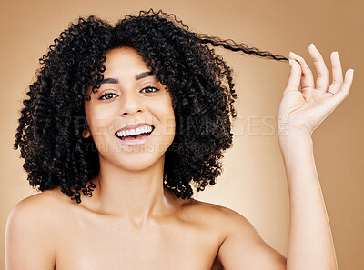 Buy stock photo Curly, hair strand and portrait of woman in studio for natural beauty, healthy growth and coil textures on brown background. Happy model pull afro hairstyle for salon aesthetic, keratin and treatment