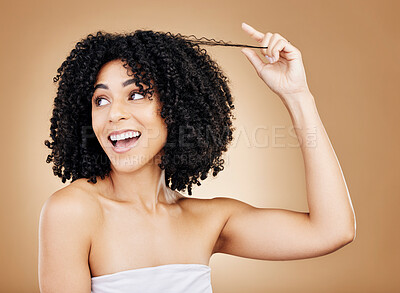 Buy stock photo Happy, thinking and a woman with an afro, hair care or stretching a hairstyle on a studio background. Smile, excited and a model or young girl with a style, grooming or idea for curls on a backdrop