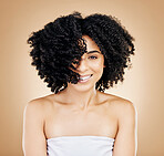 Hair, curls and portrait of woman, beauty and treatment for shine, cosmetic care and smile on studio background. Wellness, haircare and growth with strong texture and shake locks, volume and afro