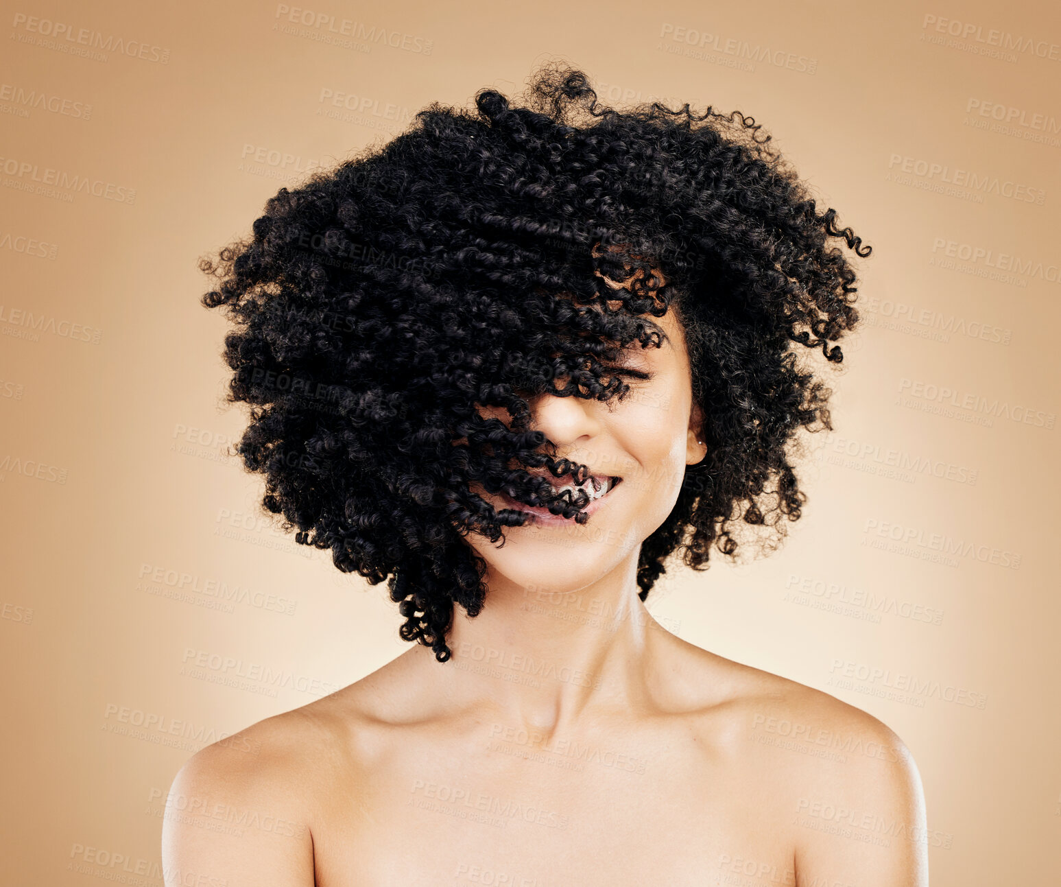 Buy stock photo Woman, curly and hair wind in afro fun on studio background for healthy hairstyle growth, texture and frizz treatment. African beauty model, shake energy and change by shampoo transformation results