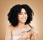 Hair, scissors with curls and portrait of woman, beauty and treatment, cosmetic care and change on studio background. Wellness, haircare and haircut with strong texture and cut locks, volume and afro