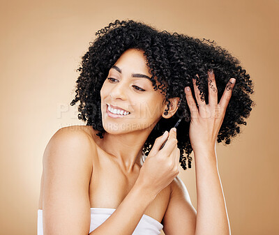 Buy stock photo Afro, hair and comb of woman in studio with healthy coil texture, natural growth or cosmetics on brown background. Happy model, curly haircare tools or brush for salon aesthetic, care or clean beauty