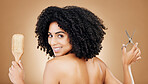 Hair care, portrait and a woman with a brush and scissors for grooming, styling or beauty. Smile, hairdresser and a young girl with an afro and tools for a hairstyle or cut on a studio background