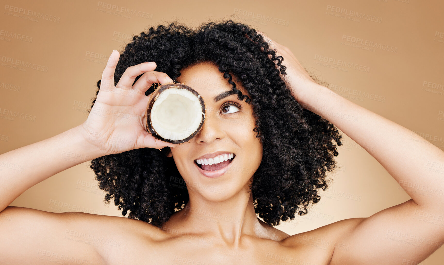 Buy stock photo Beauty studio face, happy woman and coconut for skin detox, natural wellness treatment or facial makeup. Happiness, fruit benefits and aesthetic person with food skincare product on brown background