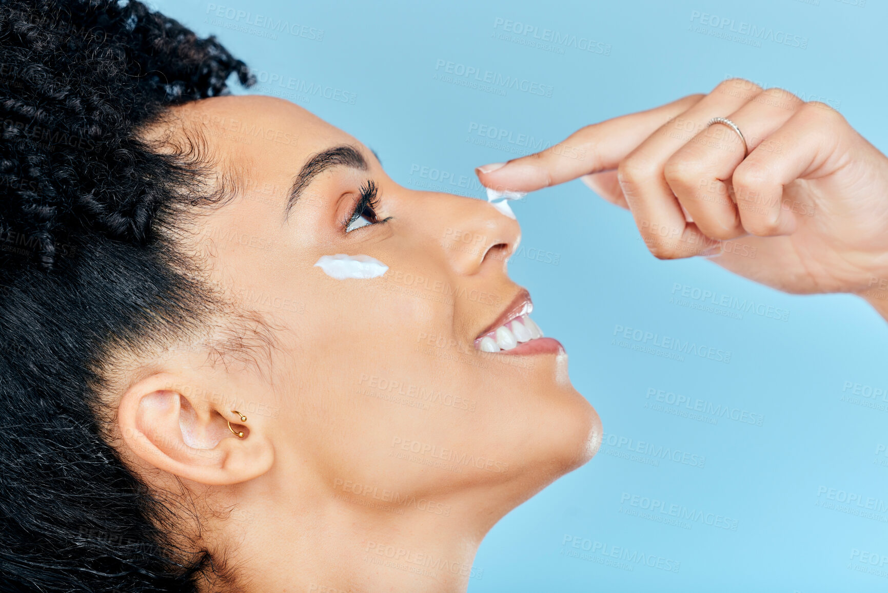 Buy stock photo Beauty skincare, face and happy woman with cream application of moisturizer, lotion or product for pimple prevention. Wellness makeup, anti aging cosmetics or studio person profile on blue background