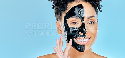 Buy stock photo Skincare, charcoal mask and portrait of happy woman for facial treatment, spa and wellness in studio. Beauty, dermatology and face of person for health, cosmetics and grooming on blue background