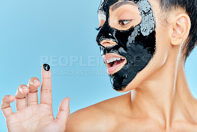 Buy stock photo Skincare, charcoal mask and finger of woman for facial treatment, anti aging detox and wellness. Beauty, studio and person with face products for health, cosmetics or grooming on blue background