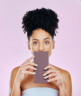 Buy stock photo Portrait, eating and woman with chocolate, sugar and diabetes on a pink studio background. Face, person and model with unhealthy food, cacao treat and sweet diet with expression, nutrition and snack