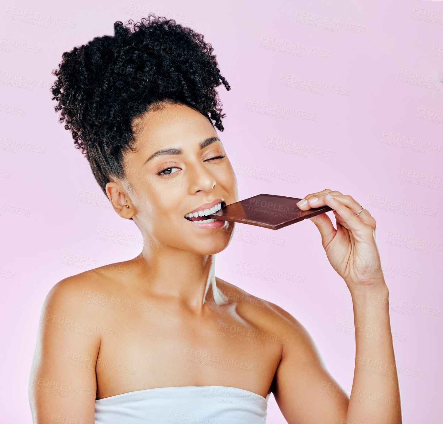 Buy stock photo Portrait, sweet diet and woman with chocolate, eating and diabetes on a pink studio background. Face, person and model with unhealthy food, cacao treat and calories with sugar, nutrition and snack