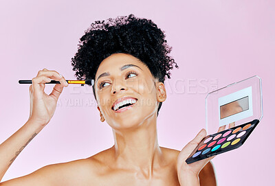 Buy stock photo Face makeup, palette and happy woman with brush, beauty routine and apply cosmetics powder, foundation or product. Happiness, skincare shine and studio person with skin treatment on pink background