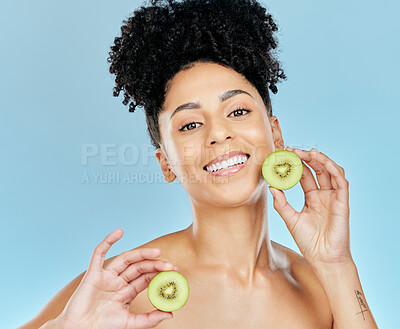 Buy stock photo Skincare, beauty and portrait of woman with kiwi in studio for glowing skin or wellness on blue background. Face, shine and female model with fruit for natural cosmetics, dermatology or treatment