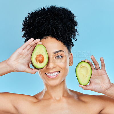 Buy stock photo Happy woman, portrait and avocado for skincare, diet or natural beauty against a blue studio background. Face of female person smile with organic fruit for nutrition, vitamin C or skin wellness