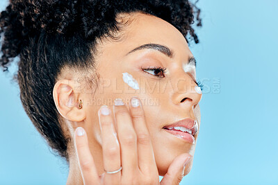 Buy stock photo Beauty, face and relax woman with cream dermatology of ointment, lotion and feel skin texture, hydration results or cosmetics. Skincare makeup, anti aging or studio model profile on blue background